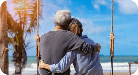 couple sitting on swing on beach